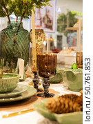 Table set for christmas or new year dinner. Decorated with pine cones and candles. Стоковое фото, фотограф Оксана Шведкова / Фотобанк Лори