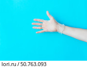 Human hand in transparent glove above bright blue background. Стоковое фото, фотограф Акимова Надежда / Фотобанк Лори