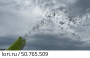 Slow motion shooting of a foam cannon where white foam flies out onto the playground to celebrate. Стоковое видео, видеограф Darya Komarova / Фотобанк Лори