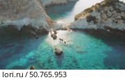 Crystal clear cove with rocks and shallow turquoise water in Kefalonia Greece. Стоковое видео, видеограф Ольга Сухарева / Фотобанк Лори