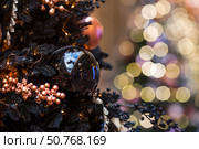Stylish Christmas background. Black Christmas tree decorations on a Christmas tree. Concept of preparing and decorating for the new year 2026. Стоковое фото, фотограф Photojuli / Фотобанк Лори