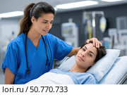 Compassionate nurse comforting patient in hospital bed. Стоковое AI-изображение, AI-художник Юрий Поздников / Фотобанк Лори