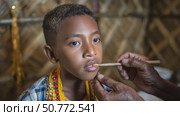 Indigenous boy receiving traditional medicine on his lips. Стоковое AI-видео, аниматор Юрий Поздников / Фотобанк Лори