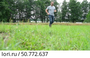 Exploring Nature a Hiker with backpack Strolling Through a Beautiful Field Beneath Vast Blue Sky. Tourist man traverses a scenic field, clear blue sky. Adventure and exploration concept. One person. Стоковое видео, видеограф Марина Демидюк / Фотобанк Лори