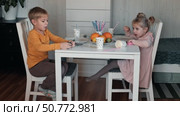 Children Drinking Juice on a Birthday Party at Home. Siblings, girls and a boy together celebrating a party, eating cake sitting at festive table. Little Kid Celebration. Surprise. Low key. Стоковое видео, видеограф Марина Демидюк / Фотобанк Лори
