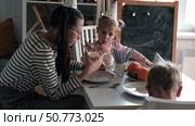 Children Drinking Juice on a Birthday Party at Home. Siblings, girls and a boy together celebrating a party, eating cake sitting at festive table. Little Kid Celebration. Surprise. Low key. Стоковое видео, видеограф Марина Демидюк / Фотобанк Лори