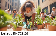 Woman Planting Saplings in Community Garden: A Scene of Urban Gardening and Volunteerism. Стоковое AI-изображение, AI-художник Данила Большаков / Фотобанк Лори