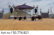 ELANTSY, IRKUTSK REGION, RUSSIA - July 5, 2025: Erdyn Games - festival of nomadic peoples of Eurasia. Video of handsome Buryat youths in national costumes dancing fiery folk dance on open stage. Редакционное видео, видеограф Виктория Катьянова / Фотобанк Лори