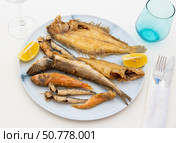 On white background, there is plate with fried fish of different varieties. Стоковое фото, фотограф Яков Филимонов / Фотобанк Лори