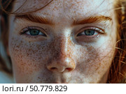 Close up of redhead woman with freckles showing her beautiful blue eyes. Стоковое AI-изображение, AI-художник Иван Рябоконь / Фотобанк Лори