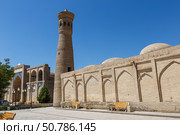 Explore Khoja Kalon Minaret in Bukhara, Uzbekistan under the clear blue sky (2024 год). Редакционное фото, фотограф Михаил Пряхин / Фотобанк Лори
