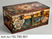 Closed wooden hope chest showing painted flowers and metal hardware. Стоковое AI-изображение, AI-художник Иван Рябоконь / Фотобанк Лори