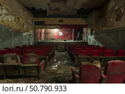 Decaying theater showing signs of vandalism and neglect. Стоковое AI-изображение, AI-художник Иван Рябоконь / Фотобанк Лори