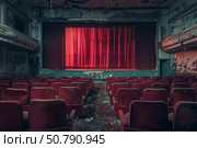 Red curtain illuminating empty seats in decaying theater. Стоковое AI-изображение, AI-художник Иван Рябоконь / Фотобанк Лори