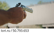 Man holding revolver aiming and firing during shooting practice at target range. Стоковое видео, видеограф Igor Tichonow / Фотобанк Лори
