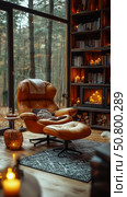 Autumn Interior Retreat: Reading Nook with Fireplace and Forest Window, a peaceful setting. Стоковое AI-изображение, AI-художник Данила Большаков / Фотобанк Лори