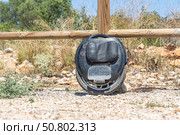 Electric unicycle leaning against wooden fence. Стоковое фото, фотограф Татьяна Куклина / Фотобанк Лори