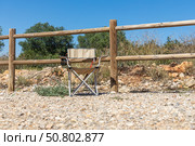 Foldable camping chair by wooden fence. Стоковое фото, фотограф Татьяна Куклина / Фотобанк Лори