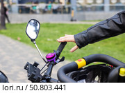 An individual is currently making contact with the handlebars of a bicycle. Стоковое фото, фотограф Аксенова Вера / Фотобанк Лори