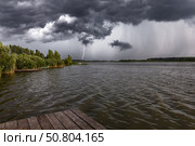 Молния в темном вечернем небе над озером летом. Стоковое фото, фотограф Андрей Иванов / Фотобанк Лори