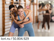 Young girl practicing self-defense techniques in pair. Стоковое фото, фотограф Яков Филимонов / Фотобанк Лори