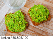 Beer snacks are laid out on plate - portion with two guacamole sandwiches. Стоковое фото, фотограф Яков Филимонов / Фотобанк Лори