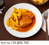 French fries and piece of hot fried chicken stuffed with cheese is served on large white platter. Стоковое фото, фотограф Яков Филимонов / Фотобанк Лори