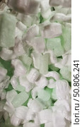 Colorful packaging peanuts mixed with light green foam pieces in a box. Стоковое видео, видеограф Татьяна Лобанова / Фотобанк Лори