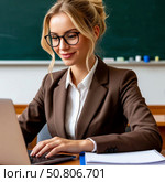 A female teacher works on a laptop, fills in an electronic diary. Стоковое AI-изображение, AI-художник Ирина Гильмуллина / Фотобанк Лори