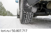 A car on a winter studded road on a snowy road. Стоковое фото, фотограф Igor Skripachev / Фотобанк Лори