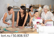Group of happy attendees of dressmaking courses engaged in different activities. Стоковое фото, фотограф Яков Филимонов / Фотобанк Лори