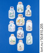 Novosibirsk, Russia - May 30, 2025: Vinyl stickers in a playful cartoon style featuring a whimsical world inside a glass jar. These designs showcase adorable cats and puppies surrounded by lush greenery, colorful flowers, and tiny creatures, creating a charming and lively scene. Редакционное фото, фотограф Виталий Сова / Фотобанк Лори