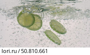 Lime Slices falling deeply under water. Shot on super slow motion camera 1000 fps. Стоковое видео, видеограф Андрей Армягов / Фотобанк Лори