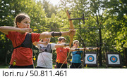 Young Russian archers aiming at targets in a lush forest setting. Стоковое AI-изображение, AI-художник Ольга Невская / Фотобанк Лори