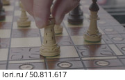 A man moves a chess piece on a chessboard. Стоковое видео, видеограф Дмитрий Нечаев / Фотобанк Лори
