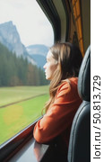 Cinematic and symmetric beautiful shot of young travelling woman, adventurer and female nomad look out of open window of tourist train in swiss mountains. Travel inspiration. Стоковое AI-видео, аниматор Sergey Grishin / Фотобанк Лори