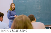 Female teacher giving lecture to university students in classroom. Стоковое видео, видеограф Яков Филимонов / Фотобанк Лори