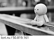 Sad plush toy sitting alone on wet bench in rain symbolizing loneliness, abandonment, sadness. Стоковое AI-изображение, AI-художник Гайфуллина Дина / Фотобанк Лори