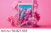 Tablet Presentation: An explosion of vibrant colored dusts behind a digital device, for display of screen technology. Стоковое AI-изображение, AI-художник Данила Большаков / Фотобанк Лори