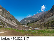 Ala-Archa Park Mountain landscape featuring steep slopes, rocky terrain. Flowing river, winding trail. lush vegetation, distant peaks. Trekking, hiking, mountaineering. Adventure travel, exploration. Стоковое фото, фотограф Андрей Ка / Фотобанк Лори