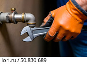 A plumber repairs pipes. Стоковое AI-изображение, AI-художник Галина Эмберг / Фотобанк Лори