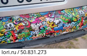 Car bumper showcasing vibrant, colorful graffiti stickers. Редакционное видео, видеограф Данил Руденко / Фотобанк Лори