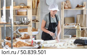 Woman baker cutting dough pieces with scraper and weighing in scales. Стоковое видео, видеограф Яков Филимонов / Фотобанк Лори