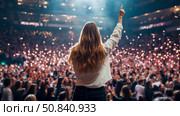 Concert euphoria: A performer unites crowd with song, her arm raised, the audience responding with illuminated phones, creating an immersive experience. Стоковое AI-изображение, AI-художник Данила Большаков / Фотобанк Лори