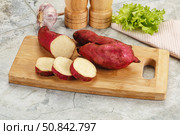Raw red batat with slices. Стоковое фото, фотограф Андрей Старостин / Фотобанк Лори