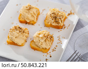 Four hummus sandwiches are laid out on plate - traditional snack of Middle East. Стоковое фото, фотограф Яков Филимонов / Фотобанк Лори