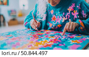 Concentrated Artistic Focus: Woman Engaged in Colorful Abstract Painting. Стоковое AI-изображение, AI-художник Данила Большаков / Фотобанк Лори