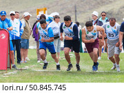 ELANTSY VILLAGE, IRKUTSK REGION, RUSSIA - July 5, 2025: Erdyn Games - festival of nomadic peoples of Eurasia. Athletes runners at start of traditional cross-country race around the sacred Erd mountain. Редакционное фото, фотограф Виктория Катьянова / Фотобанк Лори