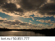Gloomy evening sky landscape with thunderclouds and water surface of the river.the sun shining through clouds over a lake. Стоковое фото, фотограф Лазаренко Светлана / Фотобанк Лори