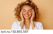 Pampering Beauty: Portrait of Smiling Woman in Bathrobe Touching Face after Spa for Skincare Routine, Wellness concept. Стоковое AI-изображение, AI-художник Данила Большаков / Фотобанк Лори